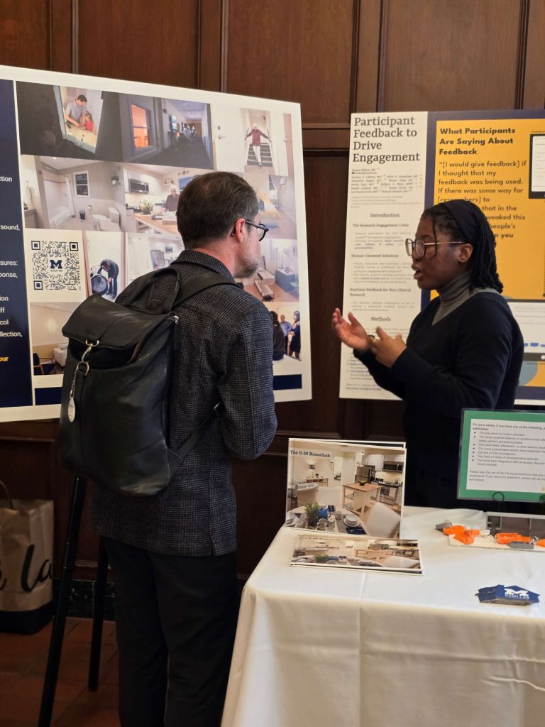 HomeLab Junior Professional Researcher Bolu Dogari speaks with an attendee at the ISR 75th Anniversary Showcase